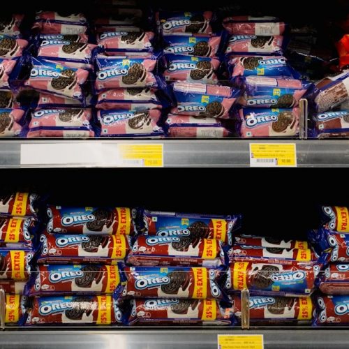 Packages of cookies neatly stacked on store shelves.