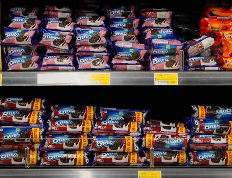 Packages of cookies neatly stacked on store shelves.