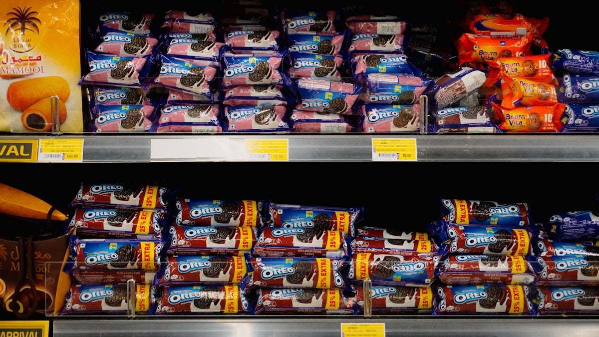 Packages of cookies neatly stacked on store shelves.