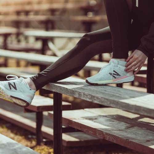 Athlete tying shoes on the bench at the track!