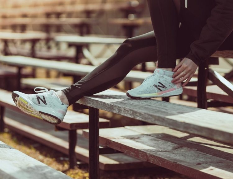 Athlete tying shoes on the bench at the track!