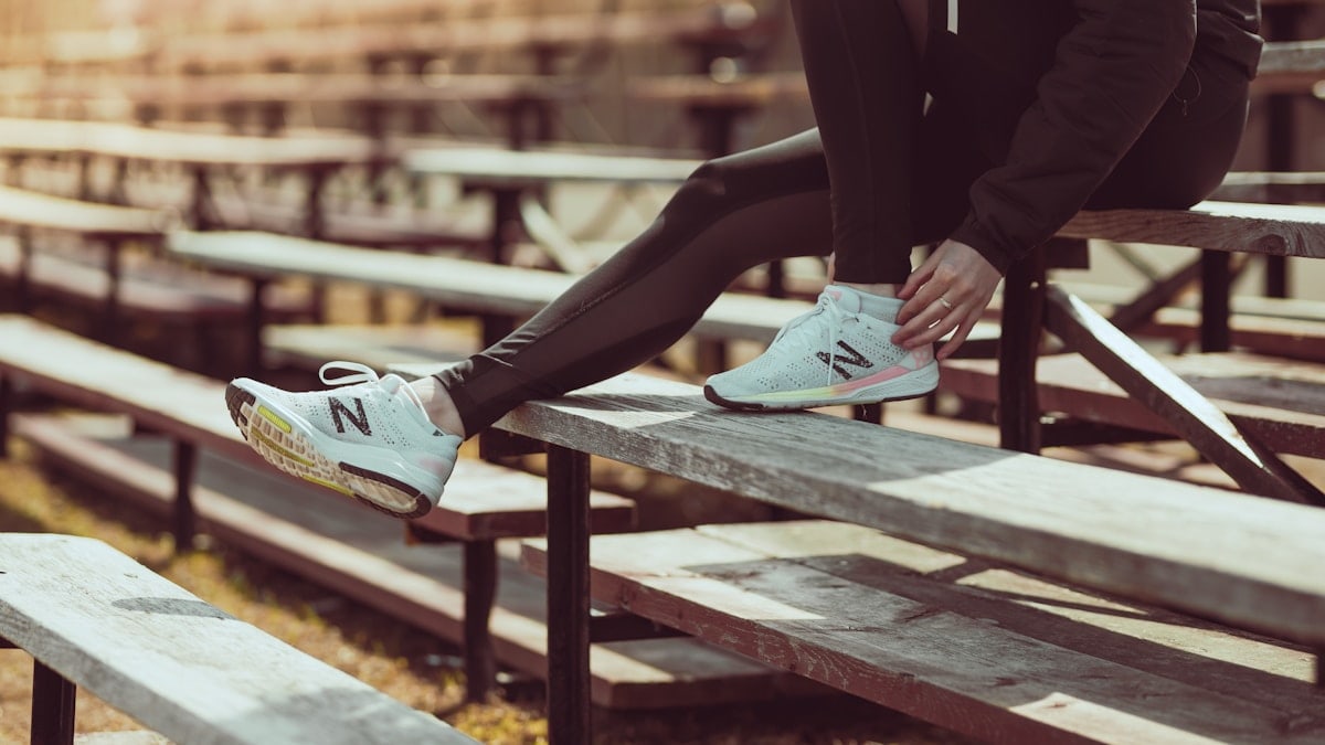 Athlete tying shoes on the bench at the track!